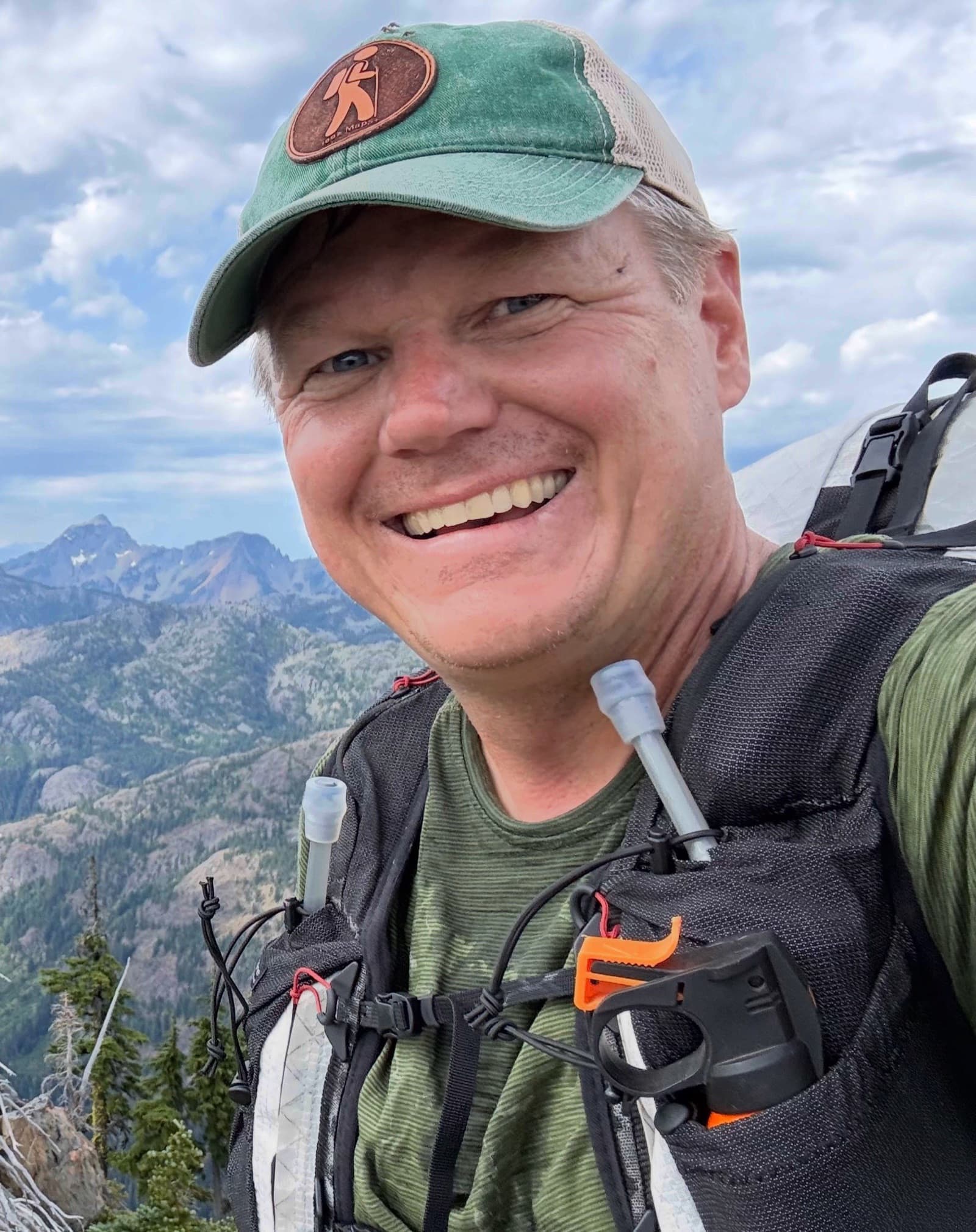 Stephen wearing his pack in the mountains, a soft flask in each shoulder strap
