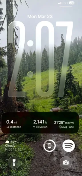 A Topo Maps+ Live Activity on the Lock Screen showing distance, elevation, and average pace